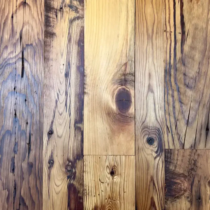 Reclaimed barn board pine flooring showing knots, saw marks, insect holes and other character.