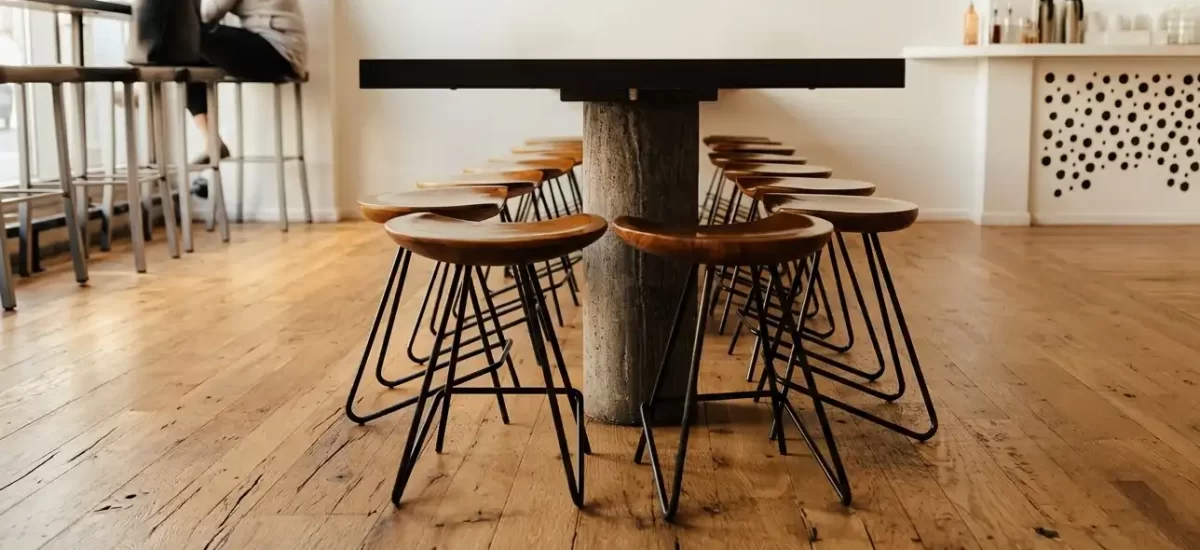 Reclaimed Oak flooring with wide plank flooring and original saw marks in a modern sunlit cafe.