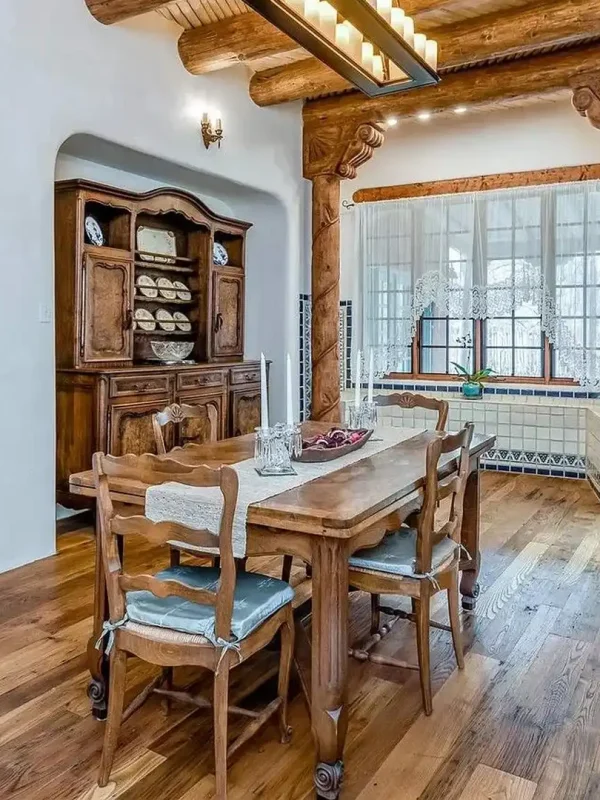 Reclaimed historic chestnut wood floors complementing a traditional dining space with ornate woodwork.