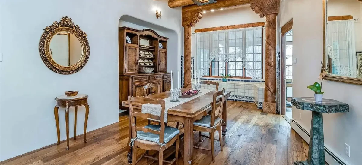 Reclaimed historic chestnut wood floors complementing a traditional dining space with ornate woodwork.