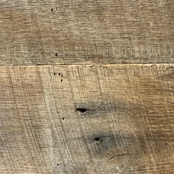 Antique barn wood planks featuring natural insect scars and meandering worm hole tracks from original interior seasoning.
