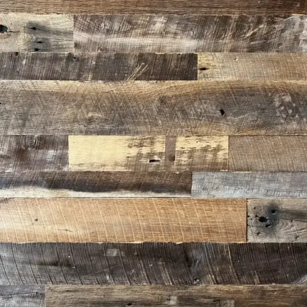 Close-up of Brown Board reclaimed barnwood planks showing a varied tactile finish and deep earthen patina.
