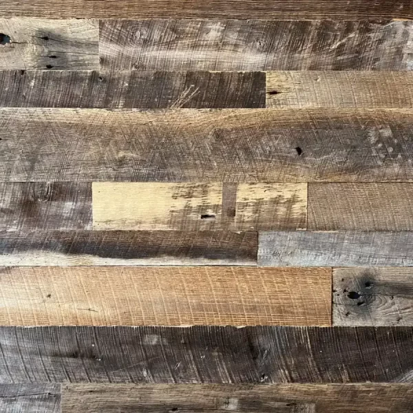 Close-up of Brown Board reclaimed barnwood planks showing a varied tactile finish and deep earthen patina.