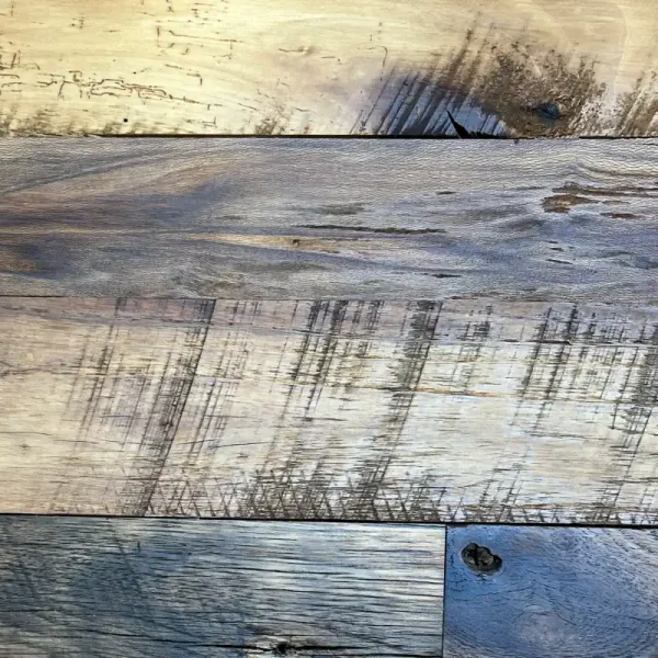 Reclaimed hardwood flooring showing original saw marks on the faces of the planks as well as other natural character.