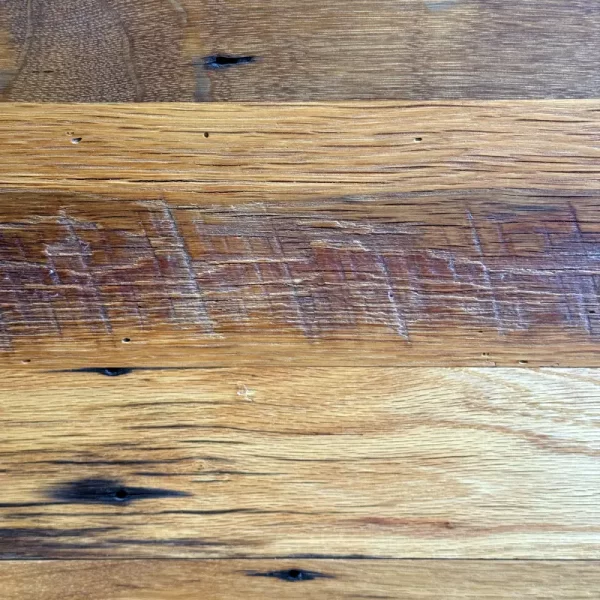 Reclaimed oak flooring showcasing the natural beauty of nail holes, saw marks, and unique character patterns.