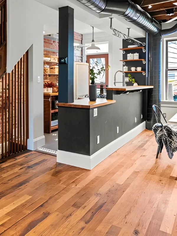 Reclaimed oak flooring complementing exposed brick and metal ductwork in an industrial loft.