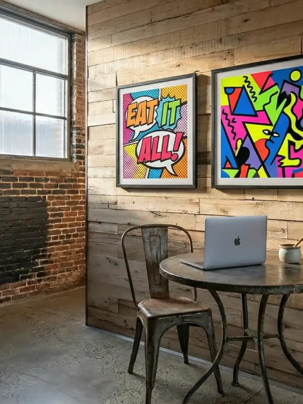 A creative office workspace pairing exposed brick with reclaimed oak wall planks. Sunlight streams across the textured wood cladding, highlighting two vibrant pop-art prints above a small meeting table.