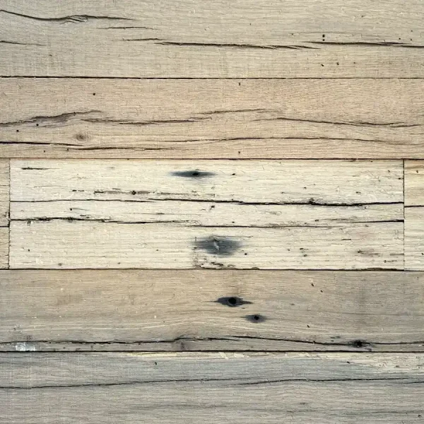 Detailed view of a stable aging stress crack, or checking, in a reclaimed oak wall board, showing the wood's natural seasoning.