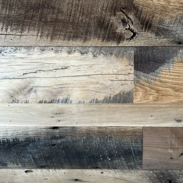 Close-up of skip planed reclaimed wood planks showcasing dark original circular saw marks and high-contrast grain.