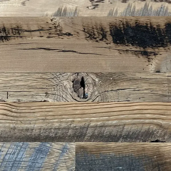Close-up of skip planed reclaimed wood planks highlighting sound knots and natural voids.