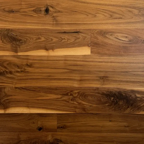 Close-up of character-grade wide plank walnut showcasing natural mineral streaks and rich tonal depth.