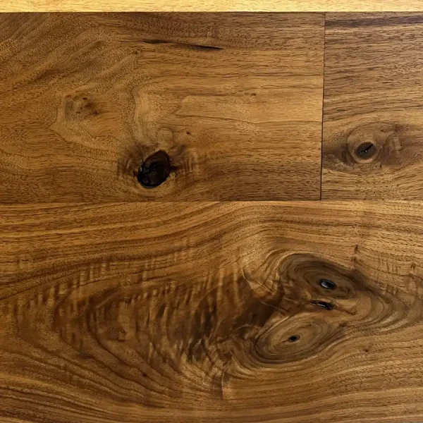Close-up of Rustic Walnut flooring highlighting authentic sound knots and natural voids in the dense grain.
