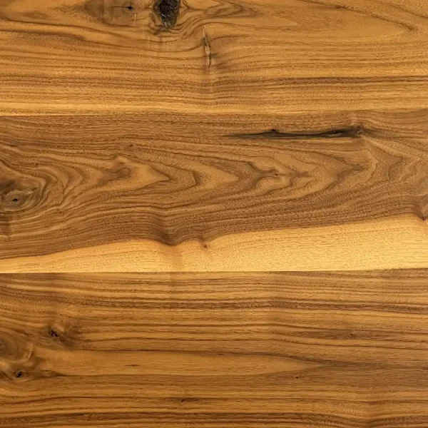 Close-up of Rustic Walnut flooring highlighting the high-contrast sapwood accents against deep heartwood grain.