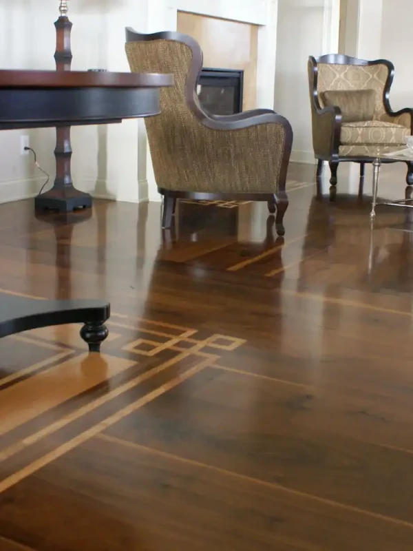 Solid Country Plank Walnut flooring featuring a custom geometric wood inlay in a formal living room.